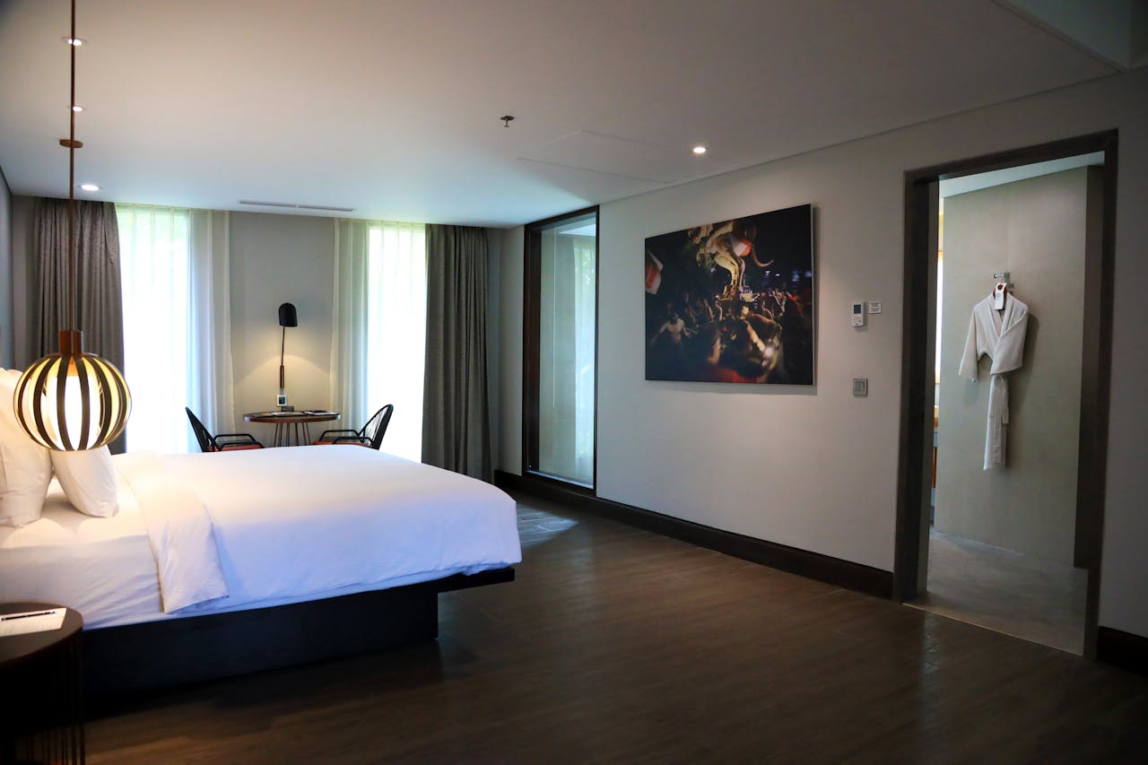 Spacious modern hotel room in Bali with stylish decor and natural lighting.